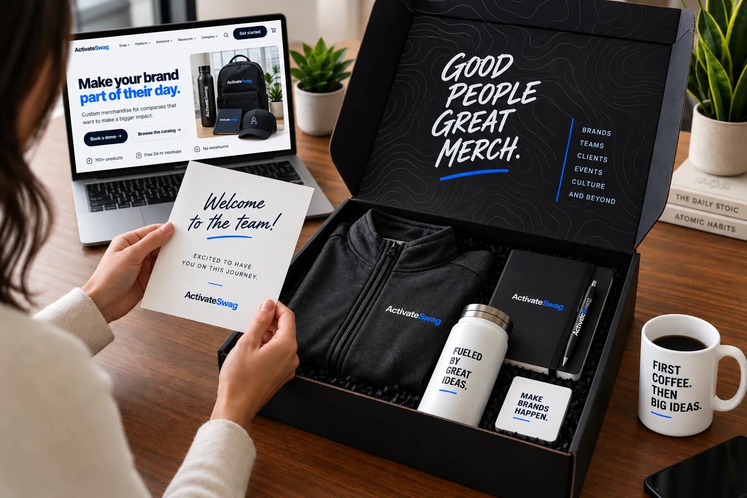 An Activate Swag welcome kit with branded apparel, a bottle, notebook, and welcome card.